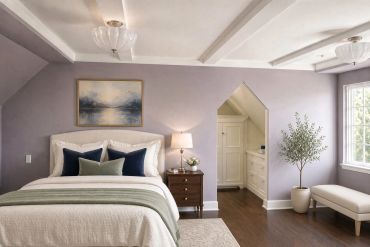 Cozy bedroom with lavender walls and natural light.