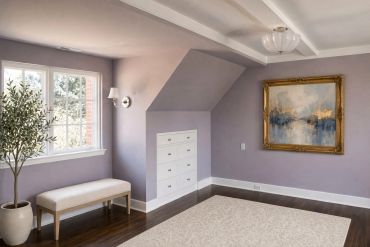 Cozy room with purple walls, bench, plant, and framed painting.