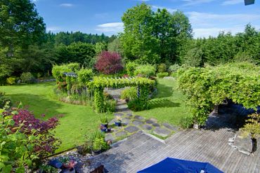 Beautiful garden with lush greenery and stone pathway.
