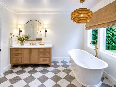 Bright bathroom with freestanding tub and wooden vanity.