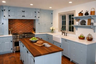 Cozy kitchen with light blue cabinets and wooden island.