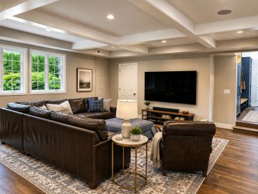 Modern living room with leather furniture and large TV.