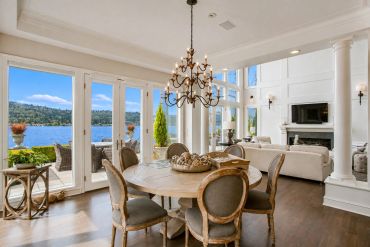 Elegant dining area with lake view and cozy living room.