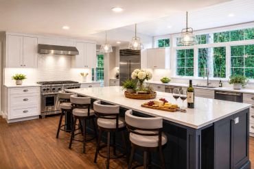 Modern kitchen with large island and bar stools.