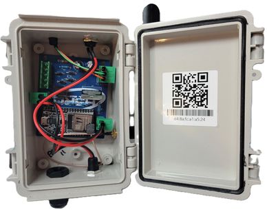 Open electronic enclosure with circuit board and wires.