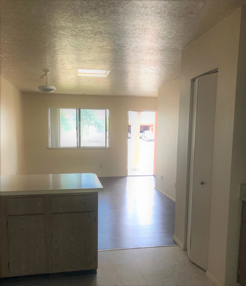 View of living room and front entry from the kitchen
