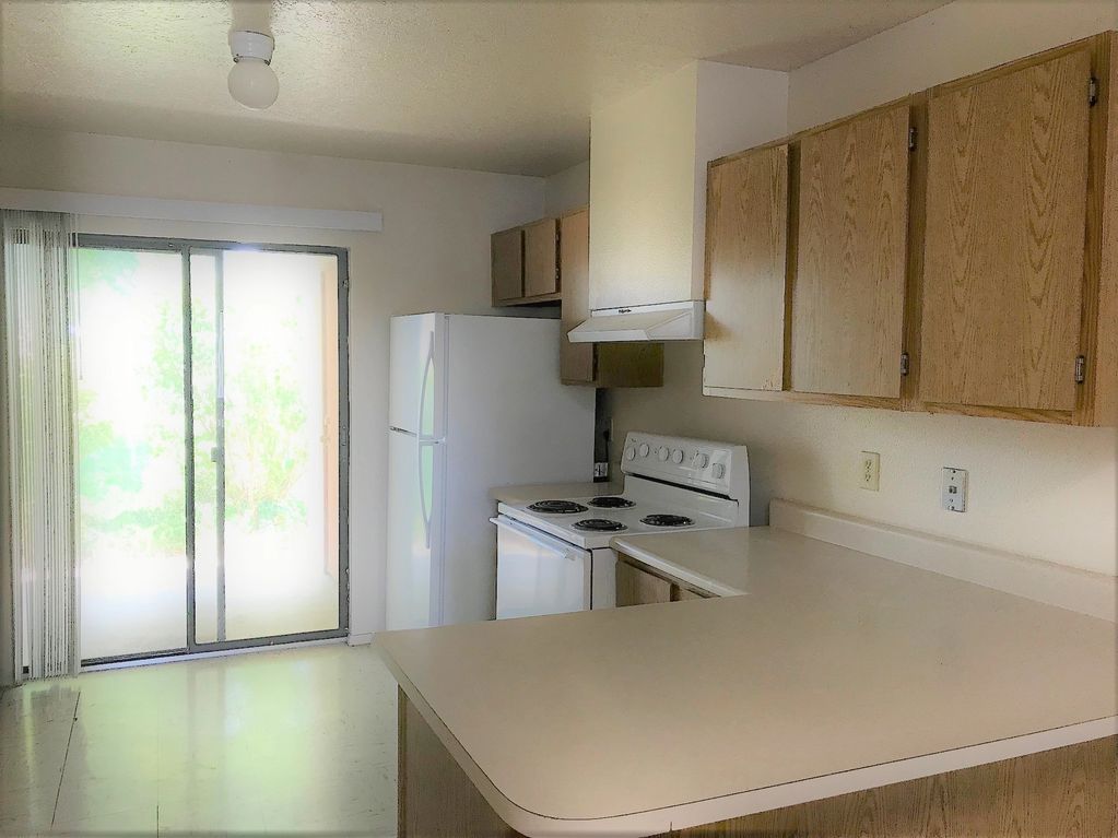 Kitchen view of large counter top space, full size appliances, and cabinets for lots of storage