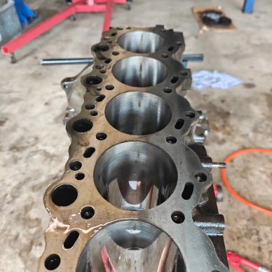 Close-up of engine cylinder block with four cylinders.