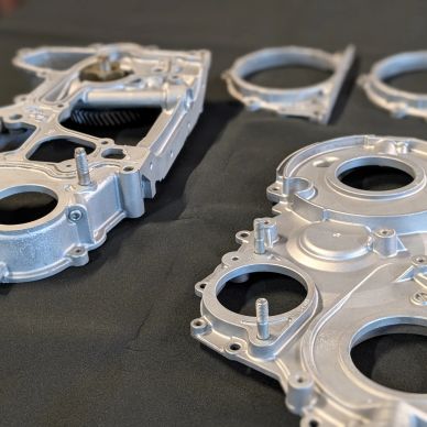 Close-up of metallic mechanical parts on a black surface.