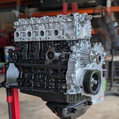 Newly painted engine block in a workshop.