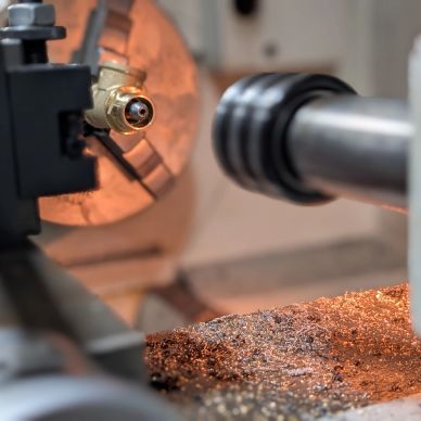 Metalworking lathe with glowing hot metal shavings.