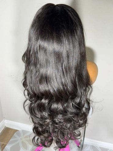 Long, wavy black hair on a mannequin head.