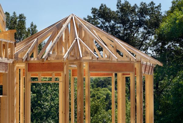 Wooden roof trusses and framing of a new house under construction