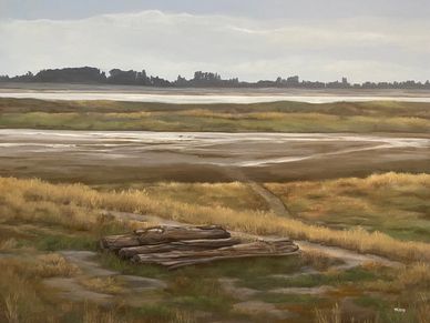 Landscape of beach dune with tide out. Drift logs left in the forefront with grasses.
