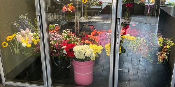 Colorful flower bouquets displayed in glass cabinets.