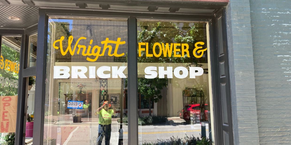 Window of Wright Flower & Brick Shop with reflection.