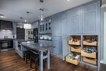 Built-in pantry drawers and two-tiered island with both counter and table height.
