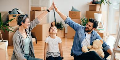 Family giving high-five while moving in.