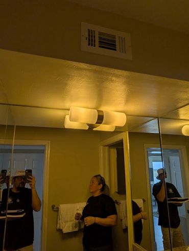 A man and woman working in a bathroom