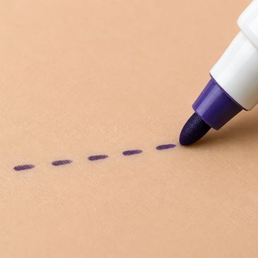 Purple marker drawing a dotted line on brown paper.