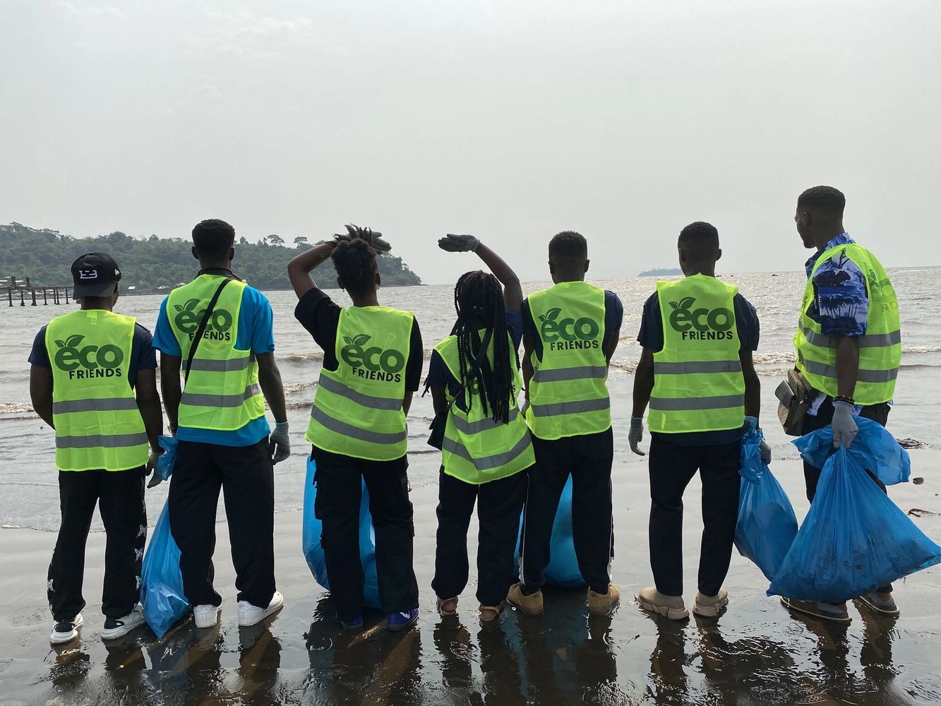 A group of volunteers in Cameroon cleaning platic off a beach