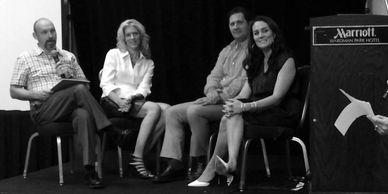 Panelists seated and laughing during a live discussion.