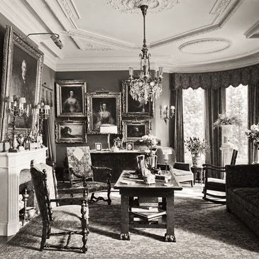 Elegant vintage living room with antique furniture and classic paintings.