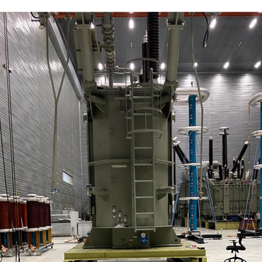 Large industrial transformer inside a spacious, well-lit facility.