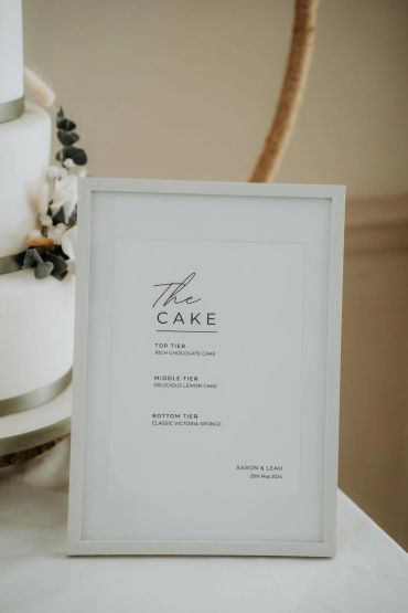Framed sign detailing wedding cake layers by Aaron and Leah.