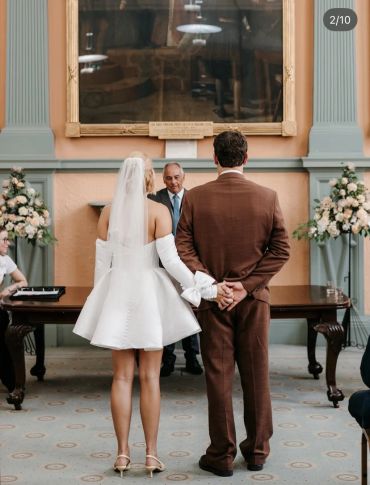 Bride and groom holding hands during wedding ceremony.