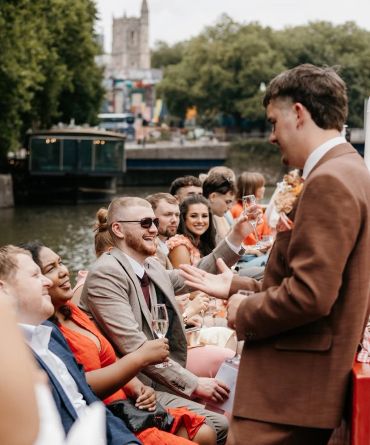 Group of people enjoying a boat party by the water.