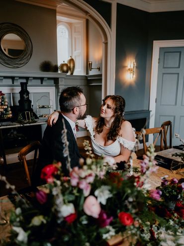 Couple shares an intimate moment during a wedding reception.