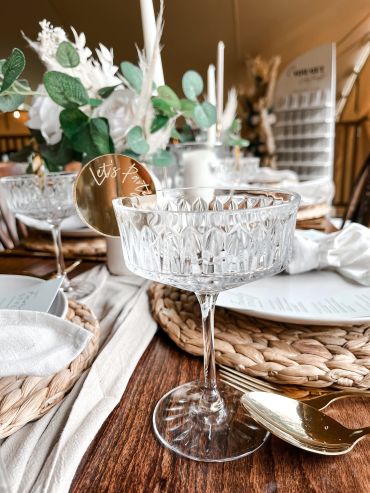 Elegant party table setting with flowers and glassware.