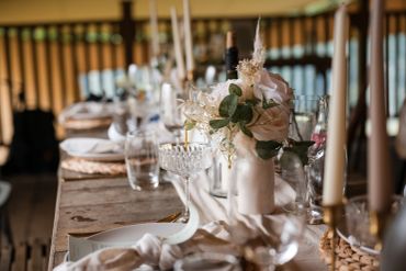 Elegant dining table set with flowers and glassware.