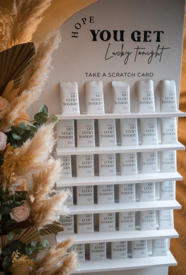 Display of 'Get Lucky Tonight' scratch cards with decorative plants.