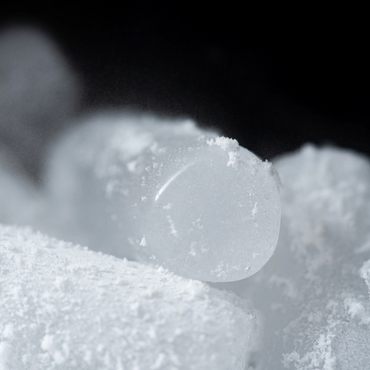 Close-up of frosted ice cubes with powdery frost.