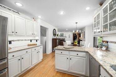 a kitchen with white themed interior