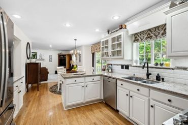 a kitchen area with white cabinets