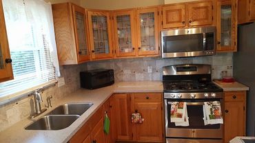 Cozy kitchen with wooden cabinets, stainless steel appliances, and a double sink.