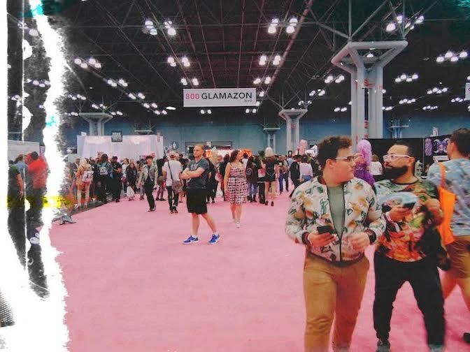 Crowd walking on pink carpet at GLAMAZON event in a large convention hall.
