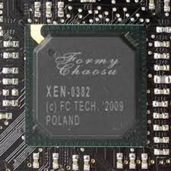 Close-up of a Formy XEN-0382 microchip on a circuit board.