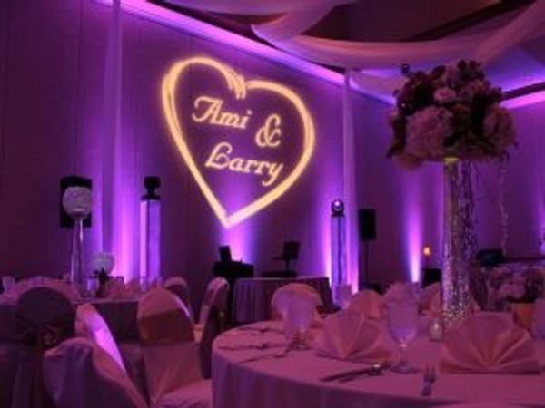 Gobo light with Bride & Groom's names projected on wall at wedding reception