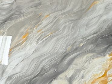 Swirling abstract patterns in gray, white, and orange hues.
