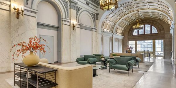 Elegant lounge with classical architecture and modern furniture.