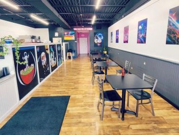 Modern café with space-themed art and cozy seating.