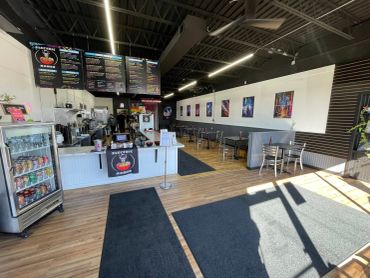 Interior of a modern ramen restaurant with hanging menu boards.