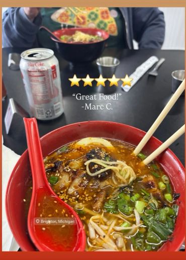 A bowl of ramen with chopsticks and a spoon, plus a Diet Coke can.