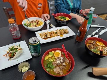 A table with various Asian dishes and drinks.
