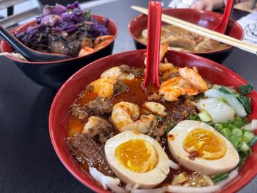 Bowls of assorted ramen with shrimp and eggs.