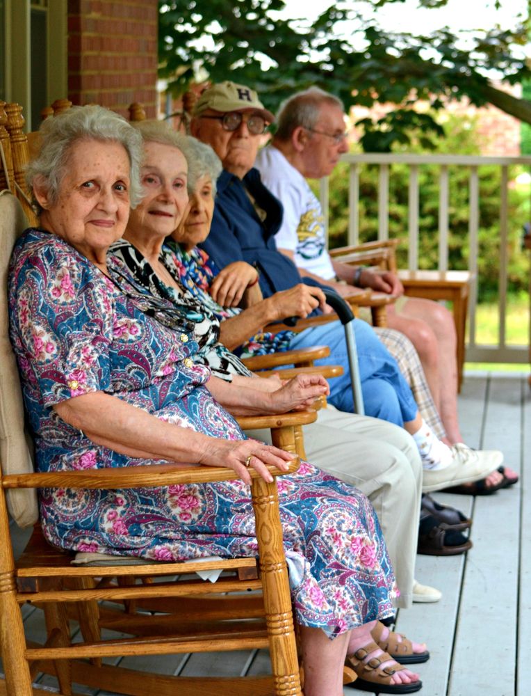 elderly residents enjoying an afternoon on the front porch